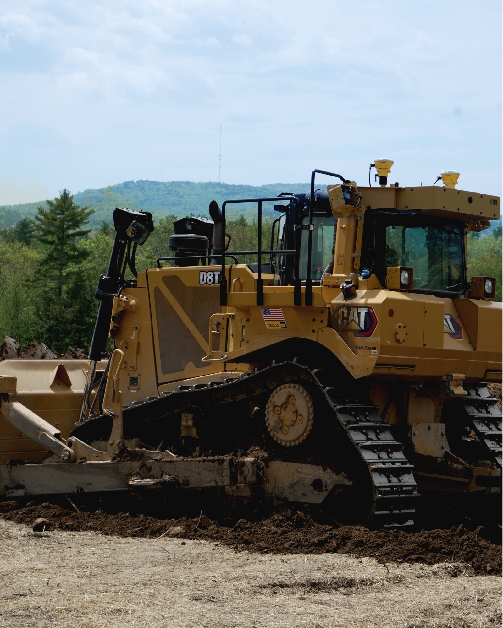 A tracked dozer working ground on an open site.